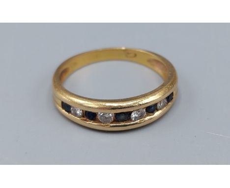 An 18ct Gold Diamond and Sapphire half eternity ring, ring size Q, 4gms