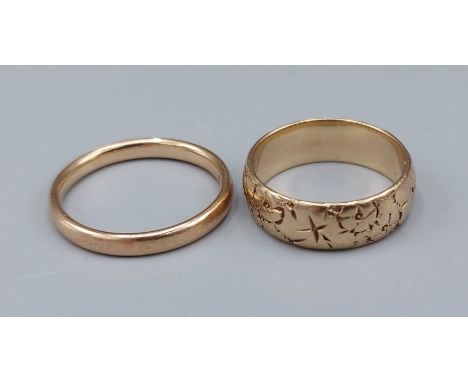 A 9ct gold engraved band ring together with a 9ct gold wedding band, 6.7gms