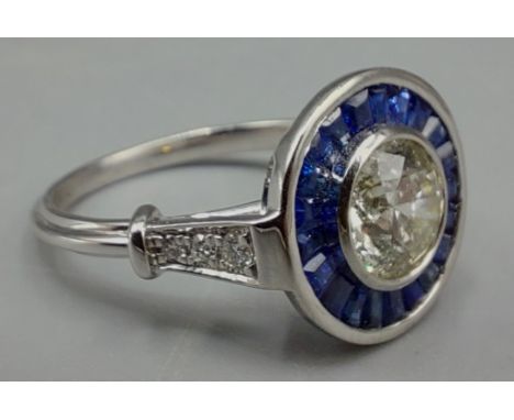 An Art Deco style Platinum, Diamond and Sapphire cluster ring set with central 1.01ct Diamond surrounded by Baggett cut Sapph