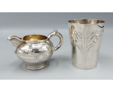 An 800 mark silver beaker with silver gilt interior together with a Russian silver cream jug marked 84, 6ozs