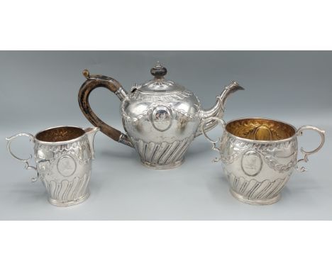 A Victorian three piece tea service, comprising of teapot, cream jug and sucrier all embossed decorated, London 1899 markers 