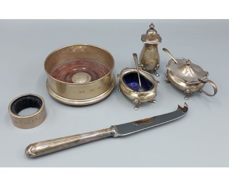 A Birmingham silver three piece condiment set comprising mustard, pepper and salt, 4ozs together with a silver bottle stand, 