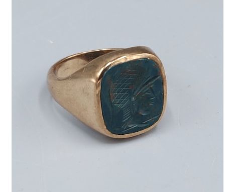 A 9ct gold Signet ring, the green stone with intaglio in the form of a classical bust, 8.6gms, ring size T