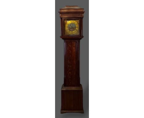 An oak and mahogany longcase clock, the rectangular hood with turned pilasters above a rectangular door, the brass and centra