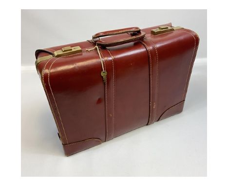 A Vintage selected imported English Topgrain Cowhide travel bag. Designed with interior section and exterior brass mounts. Co