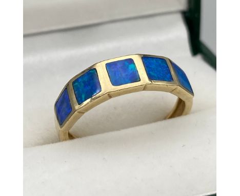 A Ladies 9ct yellow gold ring set with blue opals. [Ring size O] [2.60Grams] 