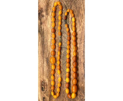A Lot of two vintage Butterscotch amber bead necklaces. One has a silver clasp. [Total weight 44.34grams] 