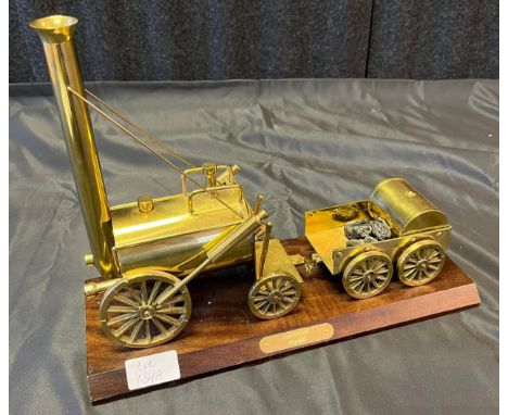 A Vintage Stephenson's Rocket brass engine and cart model. 