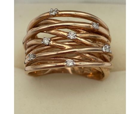 A 9ct rose gold ladies wire style ring fitted with 7 diamonds. [Ring size O] [7.82grams]