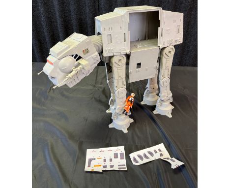 A Vintage Star Wars AT AT Walker with Luke Skywalker Pilot and loose sticker sheets. 