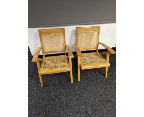 A Pair of mid century light wood and rattan weaved relaxer chairs, with makers furniture label. 