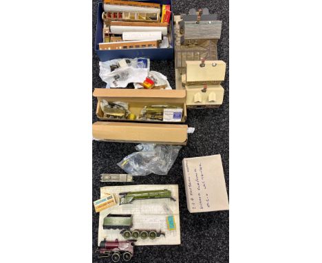 A Collection of partially built train model kits which includes blue prints, partially built wooden carriages, Kings Cross Sc