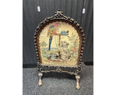 Early 19th century screen, fine needlework panel depicting dogs and birds beneath a glass front surrounded by a highly carved