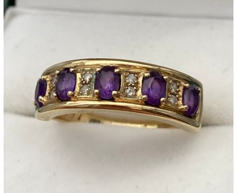 A Ladies 9ct yellow gold ring set with Amethysts and diamonds. [Ring size P] [3.31Grams] 