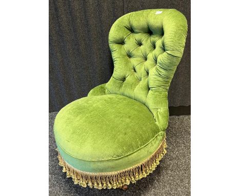 Victorian ladies chair, the arched button-upholstered back above a circular cushioned seat with tassel trim, raised on turned