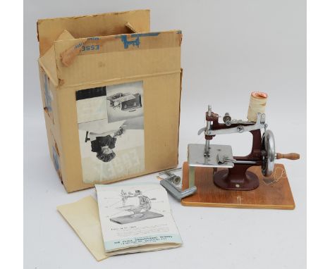 A 1960s 'Essex' miniature tabletop sewing machine, complete with clamp, instruction booklet and original outer box.