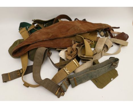 WWII collection of webbing, to include belts, rifle holsters, small bags and more, many are numbered and stamped broad arrow.