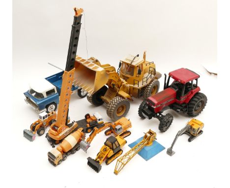 Ten die-cast model vehicles, primarily relating to construction, to include, a Discovery Wheeled Loader, an Autokran, and a H