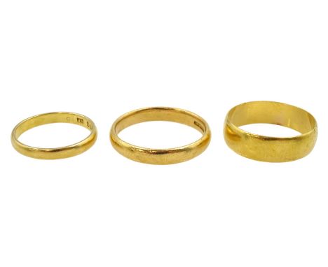 Three 22ct gold wedding bands, all hallmarkedCondition Report:Approx 11.1gm, sizes N-O, Q-R and K, widest band = 5.6mm
