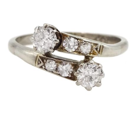 Early 20th century white gold old cut diamond crossover ring, with diamond set shoulders, stamped 18ct Plat, principle diamon