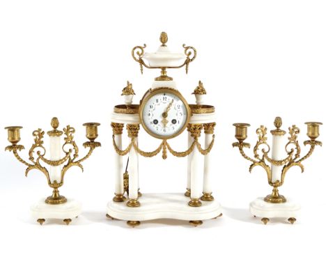 NINETEENTH-CENTURY ORMOLU AND MARBLE CLOCK GARNITUREComprising: portico mounted clock, flanked by a candelabra on either side