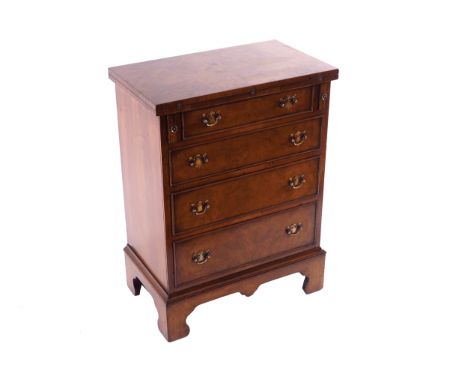 GEORGE III STYLE WALNUT BACHELORÍS CHESTof four drawers furnished with armorial brass handles, below a fold over top, raised 