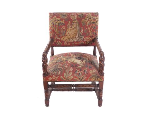 NINETEENTH-CENTURY CARVED WALNUT AND TAPESTRY UPHOLSTERED CEREMONIAL LIBRARY CHAIRwith figure fronted arms, raised on spiral 