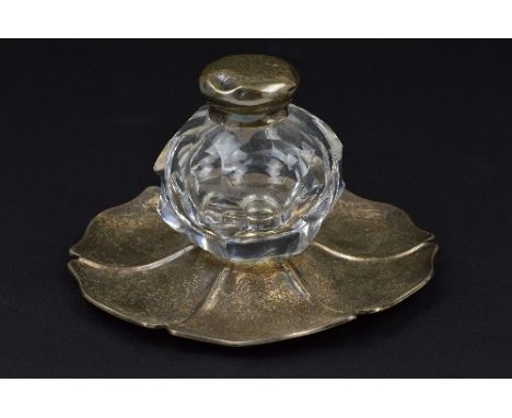 A VICTORIAN SILVER INKSTAND, of wavy circular outline, foliate engraved decoration and with crest and inscription, the centre