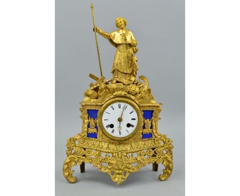 A LATE 19TH CENTURY GILT BRASS FIGURAL MANTEL CLOCK, clerical figure holding staff on a rocky base above a circular enamel di