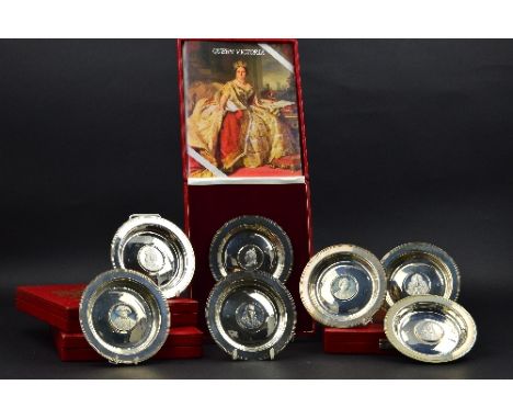 A SET OF SEVEN CASED LIMITED EDITION ROYAL LINEAGE SILVER ARMADA STYLE DISHES, each bearing a portrait of a British King or Q