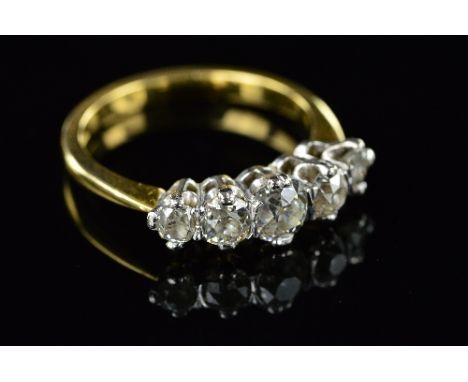 AN EARLY 20TH CENTURY DIAMOND HALF HOOP RING, old European cut diamonds graduating in size from 5.2mm -3.3mm in diameter, est