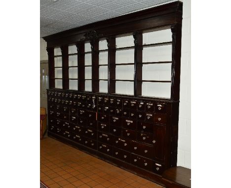 A VICTORIAN AND LATER MAHOGANY STAINED SET OF PHARMACISTS SHOP SHELVES AND DRAWERS, the cornice with central moulded detail a