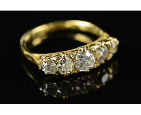 A LATE VICTORIAN DIAMOND CARVED HALF HOOP RING, five old cut diamonds graduating in size from 3.6mm to 5.2mm in diameter, cla