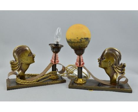 A PAIR OF ART DECO BRONZED TABLE LAMPS, the rectangular bases mounted with female busts in side profile with a scrolling stra