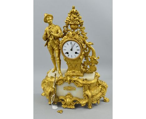 A LATE 19TH CENTURY FIGURAL GILT METAL AND WHITE MARBLE MANTEL CLOCK, cast with a male figure holding a piece of fruit and a 