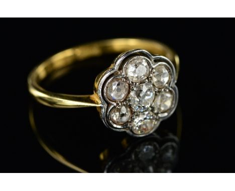 AN EARLY 20TH CENTURY DIAMOND ROUND CLUSTER RING, seven old European cut diamonds measuring on average 3.6mm in diameter each