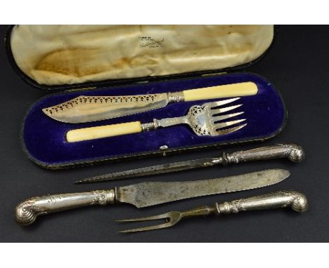 A CASED PAIR OF EDWARDIAN SILVER FISH SERVERS, with ivory handles, the blade and fork with pierced and engraved decoration, m