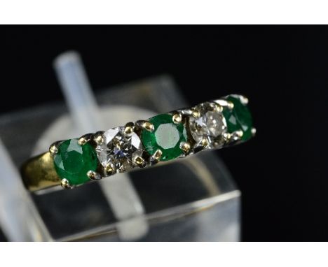 A MODERN 18CT GOLD EMERALD AND DIAMOND HALF ETERNITY RING, three round mixed cut emeralds measuring approximately 4.0mm in di