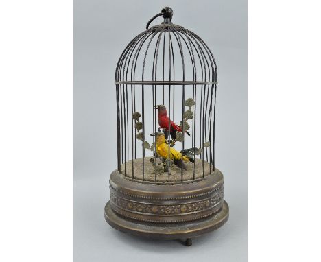 A 20TH CENTURY CLOCKWORK AUTOMATON OF TWO BIRDS IN A CAGE, both birds sing and move beaks, the red bird with moving head, cir