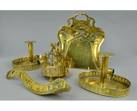 A VICTORIAN BRASS INKWELL, cast with a cherub on a section of semi-circular railing and holding an envelope, square glass ink