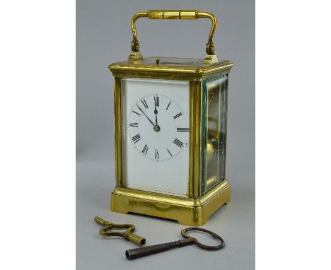 A FRENCH GILT BRASS CARRIAGE CLOCK, bevelled glass panels to the front, sides and door with an oval bevelled panel to the top