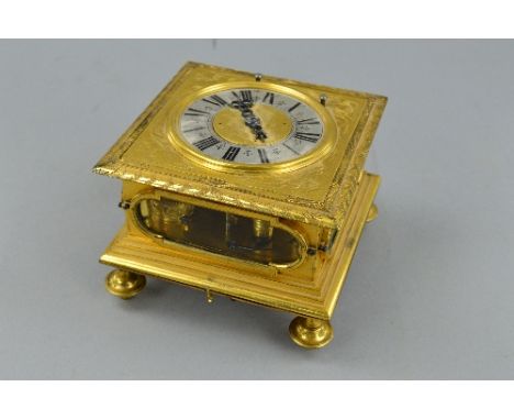 A 17TH CENTURY STYLE GILT METAL HORIZONTAL STRIKING AND REPEATING TABLE CLOCK, of square form, foliate engraved surround to t