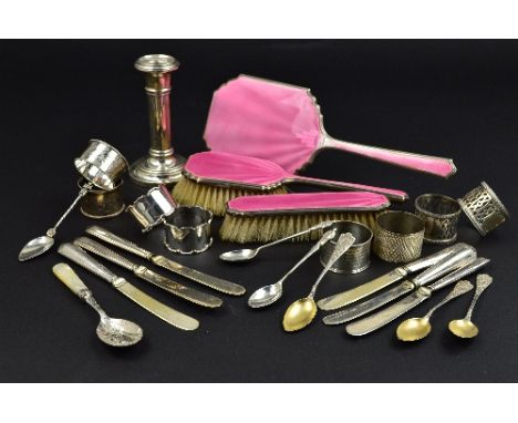 A PARCEL OF SILVER, comprising eight circular napkin rings, two of which are pairs, a three piece pink enamel dressing table 