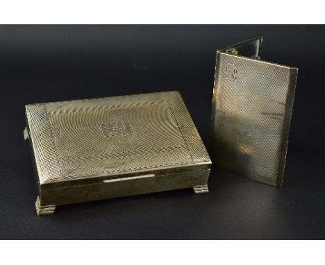 AN ELIZABETH II RECTANGULAR SILVER CIGARETTE BOX, engine turned cover with initials and date to centre, on stepped bracket fe