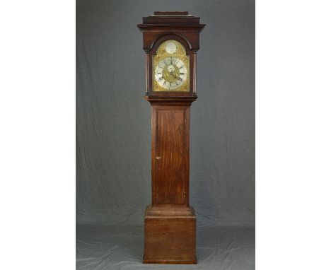 A GEORGE III MAHOGANY LONG CASE CLOCK, the hood with caddy top on half column supports flanking arched door, the brass face w
