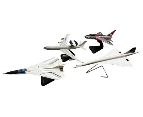 Four large-scale wooden aeroplane models on stands