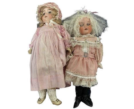 A pair of German bisque head dolls, to include: - An Armand Marseille with fixed blue eyes, open mouthed with teeth showing a