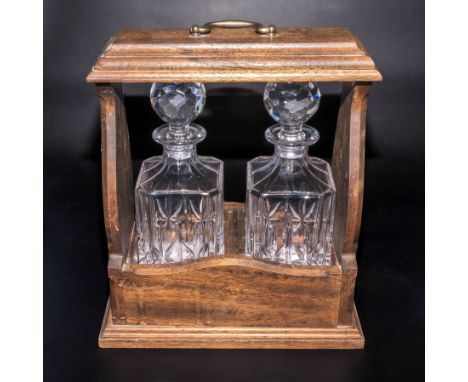 A two decanter tantalus presented by Ford Fleet