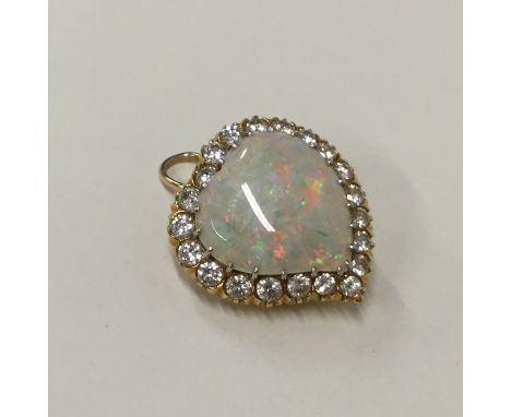 A large opal and diamond brooch in the form of a witch's heart in 18 carat gold and platinum setting. Approx. 7.1 grams. Est.