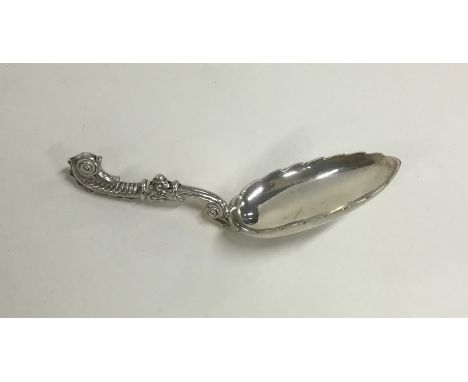A Continental silver fancy caddy spoon with scroll handle. Approx. 21 grams. Est. £30 - £50.